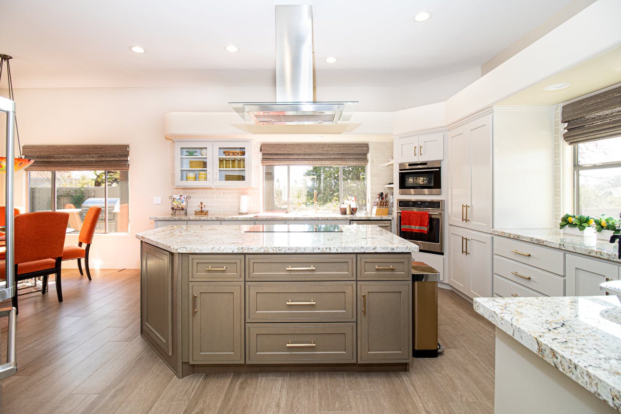 Spacious modern kitchen featuring a center island, stainless steel appliances, and elegant decor.